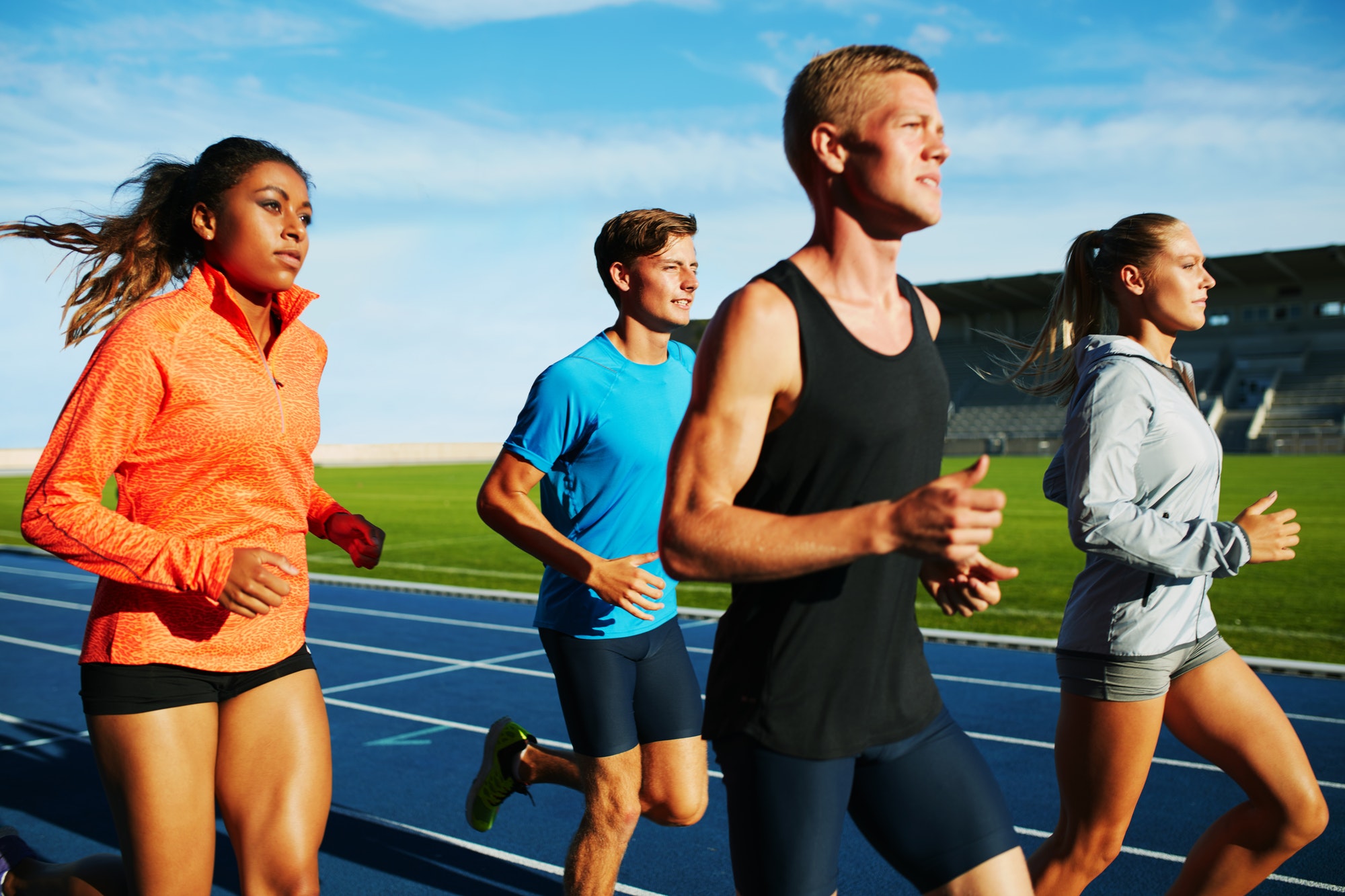 group of multiracial professional runners practicing
