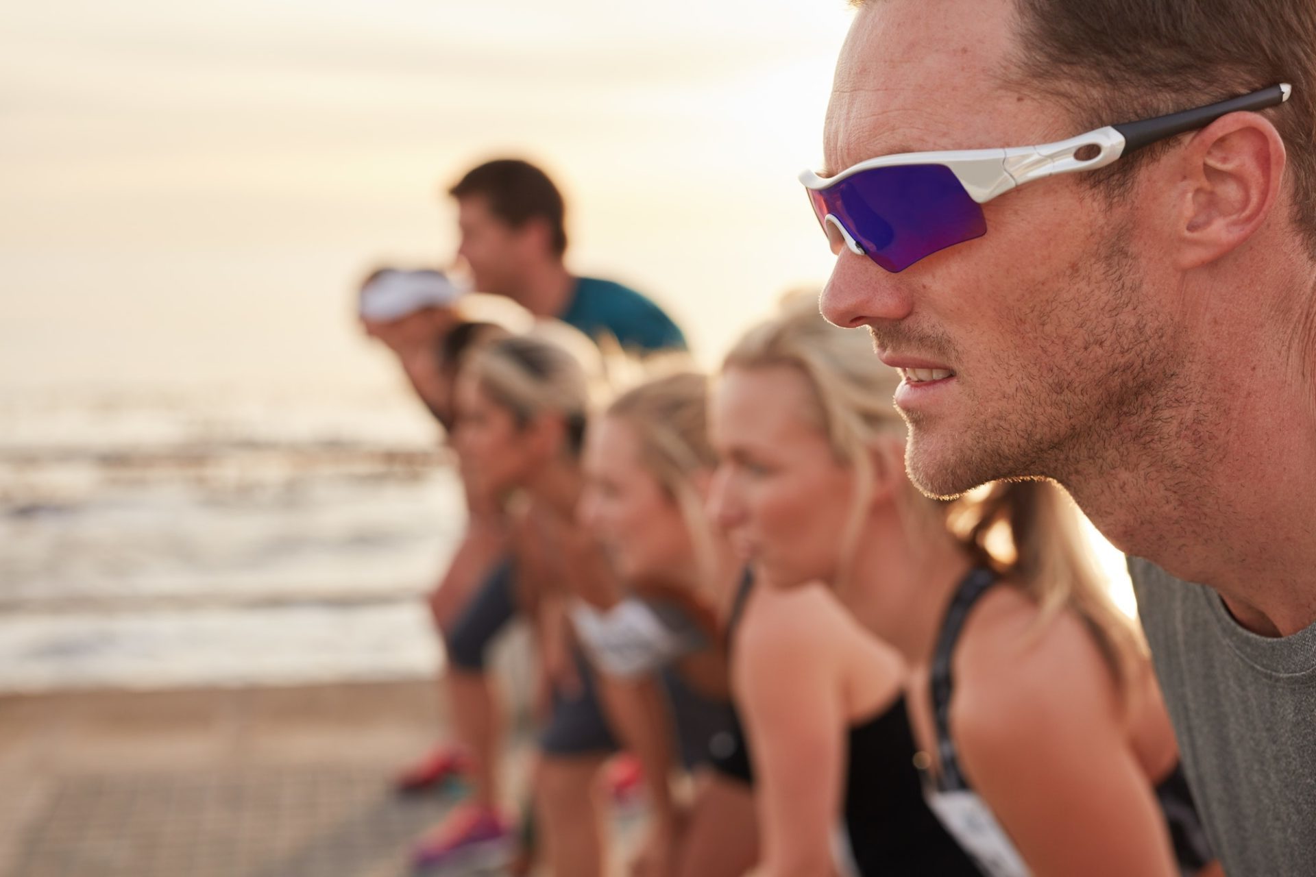young man at starting line of a marathon race e1647245449930